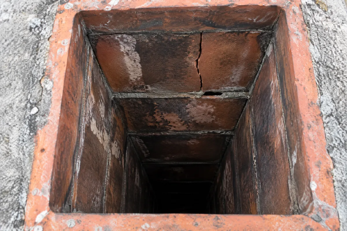 Inspection camera view of a clay tile chimney flue